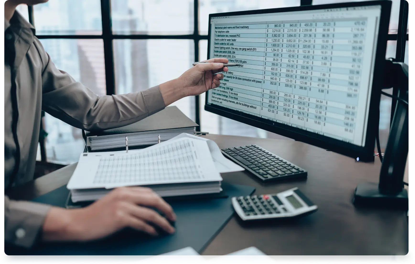 Person reviewing financial data on computer.