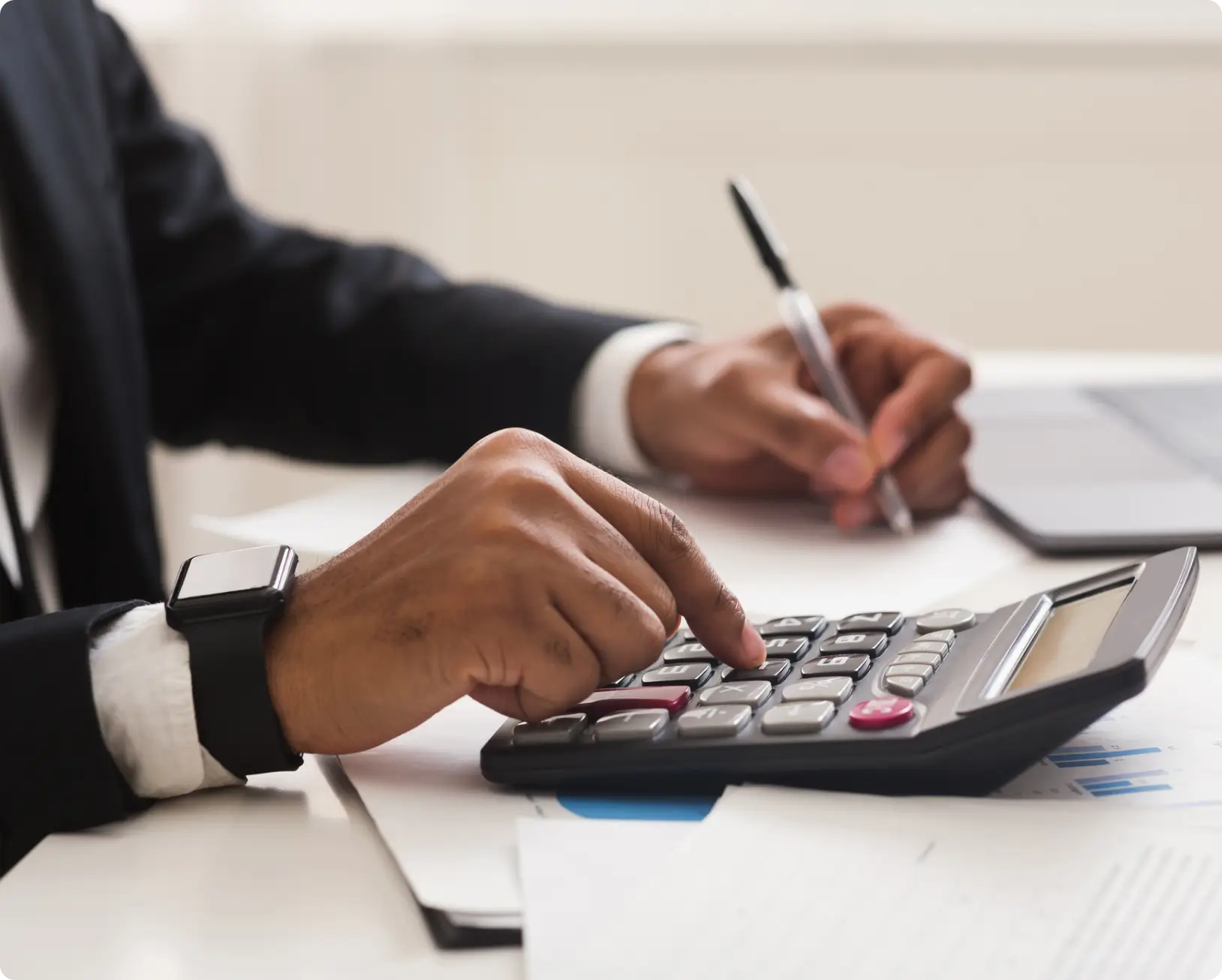 Person using calculator while working.