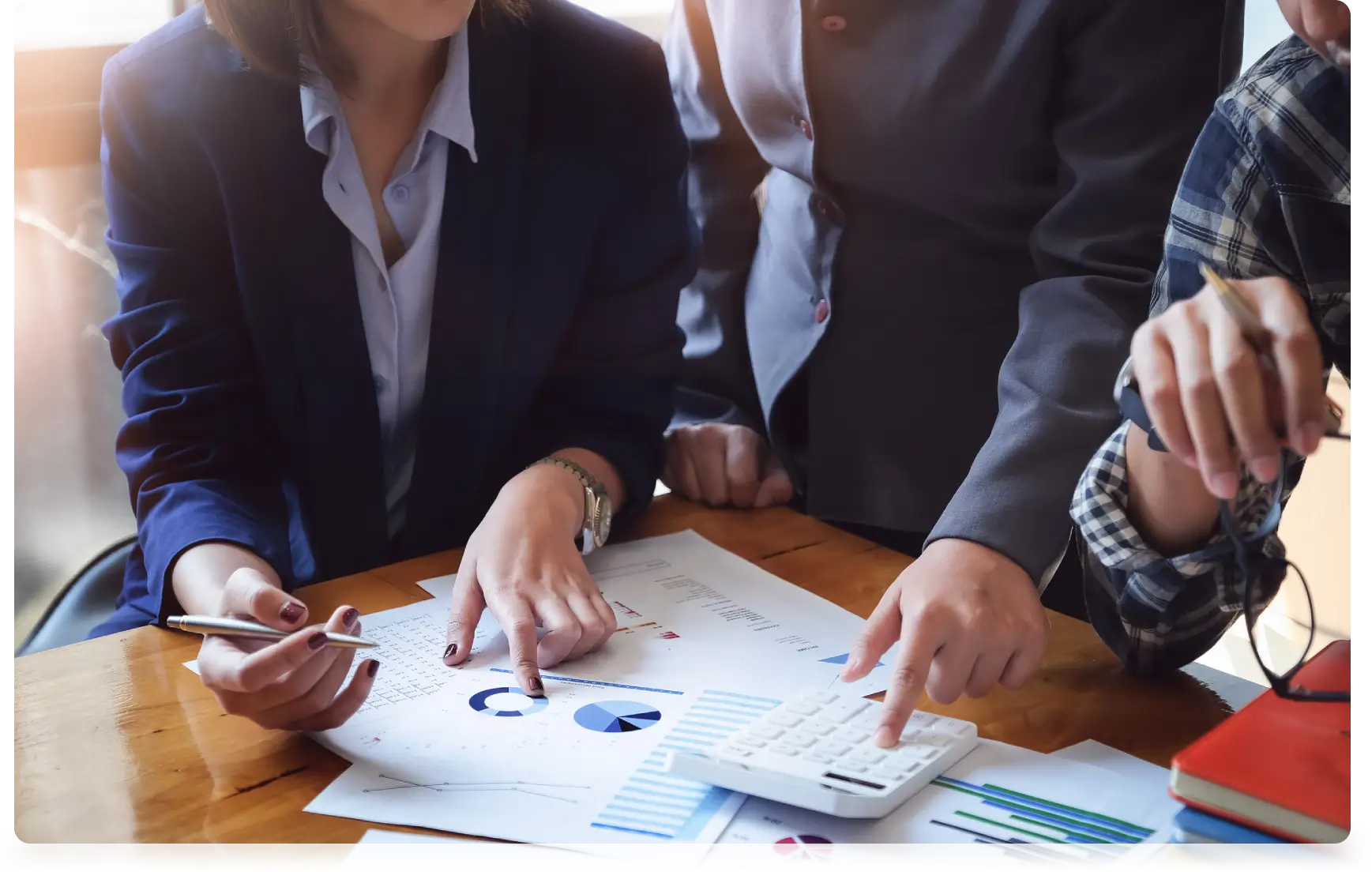 Businesspeople analyzing charts and graphs.